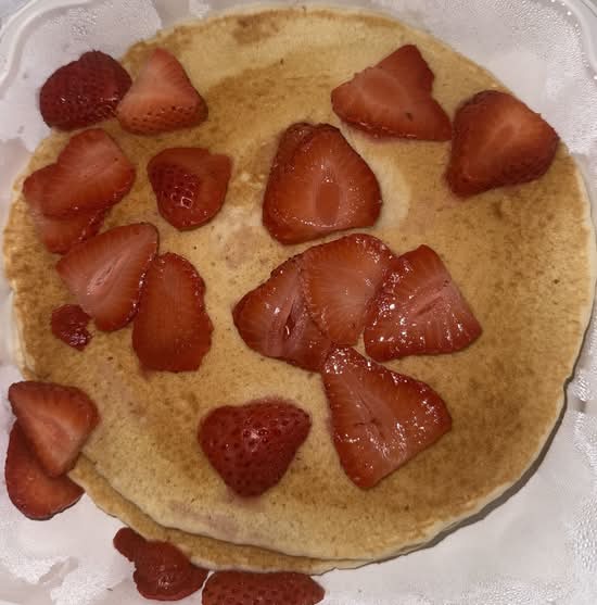 Two Pancakes with Strawberries and Whipped Cream.